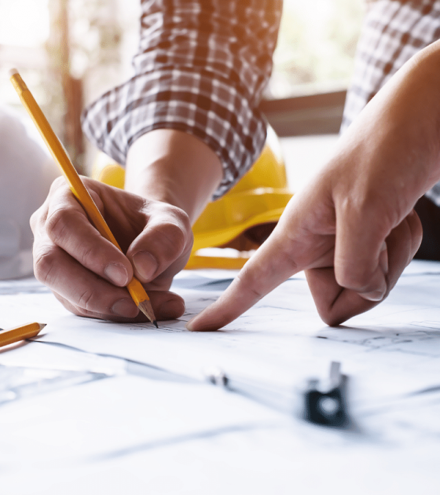 construction workers looking at blueprints